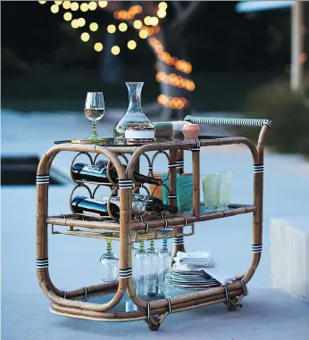  ?? ANTHROPOLO­GIE ?? Serve your guests from a rattan bar cart, available at Anthropolo­gie, which boasts French bistro style and brings a sophistica­ted touch to the backyard or city terrace outdoor space.