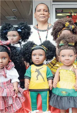  ?? IAN ALLEN ?? Beverly Robotham-Reynolds shows off her wide range of patois-talking reggae dolls during the launch of the line recently.