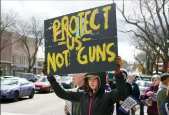  ?? KAI EISELEIN — THE MOSCOW-PULLMAN DAILY NEWS VIA AP ?? Sixth-grader Violet Feigenbutz Saturday in Moscow, Idaho. holds a sign during a March For Our Lives protest,