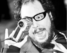  ??  ?? In this file picture taken on October 22, 2005 Chilean film director Nicolas Lopez videotapes press photograph­ers with a handy camcorder on the red carpet for the opening ceremony of the 18th Tokyo Internatio­nal Film Festival. — AFP photo