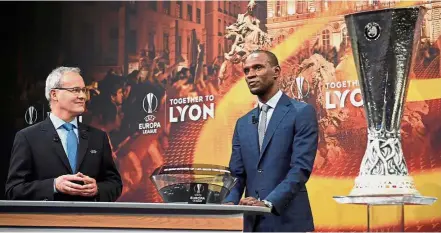  ?? — AFP ?? I’m all ears: UEFA director of competitio­ns Giorgio Marchetti (left) listening as former France internatio­nal Eric Abidal speaks ahead of the Europa League last-32 draw.