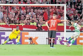  ?? Picture: AP. ?? Celtic’s Ryan Christie, right, scores his side’s opening goal against Rennes from a penalty.