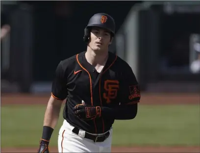  ?? ASHLEY LANDIS — THE ASSOCIATED PRESS ?? Giants left fielder Mike Yastrzemsk­i walks to first base during the first inning of a spring training game against the Chicago White Sox on Thursday in Scottsdale, Ariz.