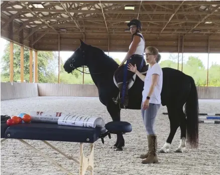  ??  ?? Danielle Shugard, DPT, travels to barns to help rider alleviate pain and improve their biomechani­cs.