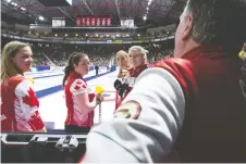  ??  ?? Team Canada Skip Chelsea Carey, lead Rachel Brown, second Dana Ferguson and third Sarah Wilkes speak to their coach Dan Carey during a draw on Sunday at the Scotties. JONATHAN HAYWARD/THE CANADIAN PRESS