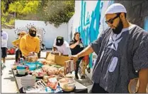  ?? ADRIANA HELDIZ U-T PHOTOS ?? From left, Pin Luon, Michael Whyte and Malcolme Muttaqee participat­e in the “spread food” contest on April 1.