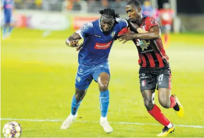  ?? NICHOLAS NUNES ?? Mount Pleasant’s Trivante Stewart (left) gets pressured by Arnett Gardens’ Joel Cunningham during their Jamaica Premier League (JPL) semi-final encounter at Sabina Park last night. The match ended 2-2.