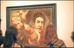  ?? GUYOT MENDOZA ?? MALBA visitors look at the famous self-portrait by David Alfaro Siqueiros, The Great Colonel (1945).