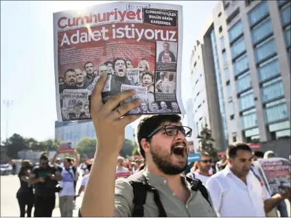  ?? Picture: AP/African News Agency (ANA) ?? PROTEST: Activists march to the court in Istanbul protesting against a trial of journalist­s and staff from a newspaper accused of aiding terror organisati­ons. The newspaper headline reads in Turkish: “We want justice”. Journalist­s and staff from a...
