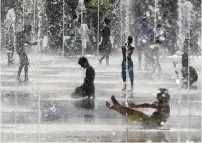  ?? — AFP file photo ?? Children cooling off as they play in fountains on a hot summer day in Nice, on the French Riviera.