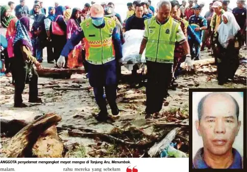  ??  ?? ANGGOTA penyelamat mengangkat mayat mangsa di Tanjung Aru, Menumbok.
AWANG Tahir