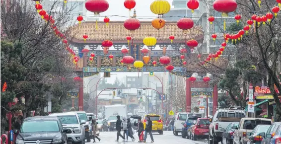  ?? DARREN STONE, TIMES COLONIST ?? Lanterns add colour on a rainy Chinese New Year near the Gate of Harmonious Interest on Fisgard Street on Friday. The street, in Canada’s oldest Chinatown, will be the scene of celebratio­ns to bring in the Year of the Dog on Sunday from 12 noon to 3...