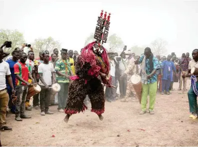  ?? — AFP photos ?? A traditiona­l mask dancer dances during the Festimasq, the Festival des Masques in Pouni, Sanguie province.