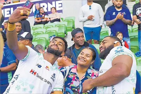  ?? Picture: FIJIAN DRUA ?? Swire Shipping Fijian Drua player Junior Ratuva takes a selfies with a fan and teammate Livai Natave after their Shop N Save Super Rugby Pacific match against Moana Pasifika at AAMI Stadium in Melbourne on Saturday. The Drua host the Crusaders in Lautoka this week.
