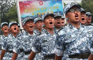  ?? EDMOND TANG / CHINA DAILY ?? Students go through their paces at the graduation ceremony of the 13th Military Summer Camp for Hong Kong Youth held at San Wai Barracks in Fanling on Sunday.