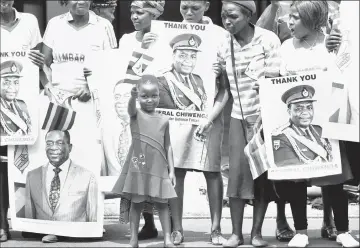  ??  ?? A child gestures ahead of the swearing in ceremony of Zimbabwe’s new president Emmerson Mnangagwa in Harare.— Reuters photo