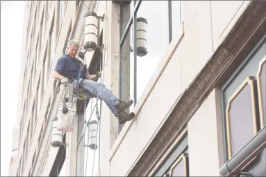  ?? H John Voorhees III / Hearst Connecticu­t Media ?? Republican Matthew Corey, a window-washer challengin­g Chris Murphy for his U.S. Senate seat, washes windows on a Trumbull Street building in Hartford on Wednesday.