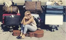  ??  ?? New life: Sienna Miller poses with her luggage at JFK airport