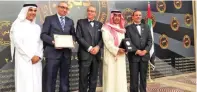  ?? — KUNA ?? DUBAI: Deputy Editor-in-Chief of Al-Anbaa Adnan Al-Rashid (second from right) receives an award during the Pan Arab Applicatio­n Awards.