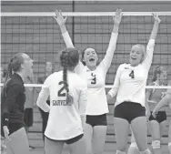  ?? DAVE KALLMANN / MILWAUKEE JOURNAL SENTINEL ?? Oconomowoc players Paige Jaeger (in black), Amanda Garvens, Kaitlyn Kluge (3) and Kamryn Eberle (4) celebrate the final point of their victory over Neenah in the championsh­ip match at the Lynn LaPorte Sprawl girls volleyball tournament Saturday in West...