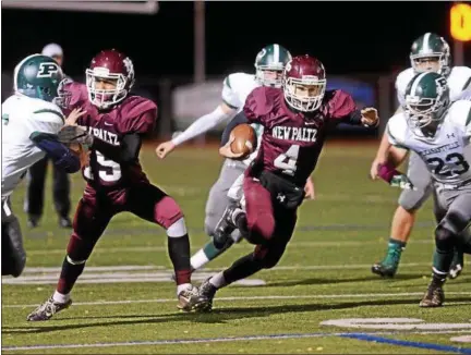  ?? PHOTOS BY TANIA BARRICKLO — DAILY FREEMAN ?? New Paltz quarterbac­k Jimmy Verney keeps the ball on a run during Friday night’s game at Dietz Stadium.