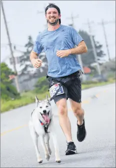  ?? KATHY JOHNSON PHOT0 ?? Brad Fraquhar and Jerry run the course for the Nova Scotia Marathon on July 22. With Jerry at the lead of the dogsled team, Fraquhar became the first Maritimer to compete in the fabled 1,000-mile Iditarod race last winter.