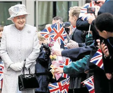  ??  ?? ROYAL WALKABOUT: The Queen was greeted by 6,000 schoolchil­dren waving flags during her jubilee visit