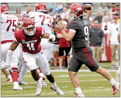  ?? NWA Democrat-Gazette/ANDY SHUPE ?? Defensive end Mataio Soli (left) chases John Stephen Jones in the Arkansas Red-White game April 6 at Reynolds Razorback Stadium in Fayettevil­le. “He’s as good using his hands as I’ve been around,” Arkansas Coach Chad Morris said.