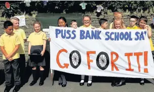  ??  ?? ●● Puss Bank School pupils cheer show their support