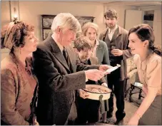  ??  ?? JOURNALIST Julia Ashton (Lily James) is offered a taste of Potato Peel Pie.