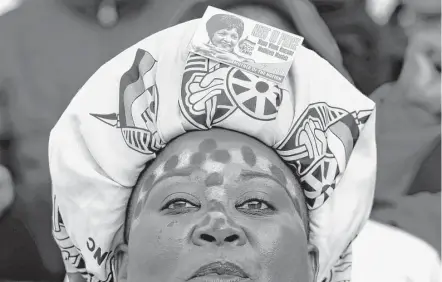  ?? Themba Hadebe / Associated Press ?? A mourner attends the funeral service of anti-apartheid icon Winnie Madikizela-Mandela on Saturday at the Orlando Stadium in Soweto, South Africa. Madikizela-Mandela, widow of Nelson Mandela, died on April 2 at age 81.