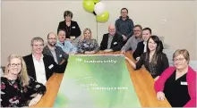  ?? JESSICA NYZNIK EXAMINER ?? Collins Barrow’s partners and chief operating officer, Kim Freeburn, back left, pose with the firm’s new name and logo at Collins Barrow’s office on Charlotte St. on Monday after changing its name to Baker Tilly.