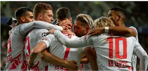  ?? FOTO: WOITAS/DPA ?? Die Spieler von RB Leipzig freuen sich über eines ihrer Tore beim 4:0 in Warschau gegen Schachtjor Donezk.