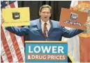  ?? ORLANDO SENTINEL ?? Gov. Ron DeSantis pulled out signs in support of gas stoves at Thursday’s news conference on drug reform in The Villages.