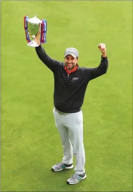  ??  ?? Richard Bland, aged 48, celebrates becoming the oldest first-time European Tour winner in his 478th event