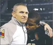  ?? File Photo/AP ?? Army head coach Jeff Monken (left) embraces running back Larry Dixon on Dec. 13, 2014, after losing 17-10 to Navy in Baltimore.