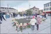  ?? PAL NORDSETH — THE ASSOCIATED PRESS ?? People gather around flowers and candles after a man killed several people on Wednesday afternoon in Kongsberg, Norway, on Thursday.