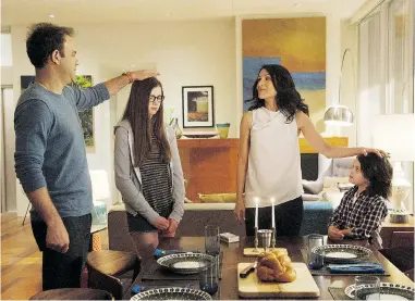  ??  ?? From left: Paul Adelstein, Conner Dwelly, Lisa Edelstein and Dylan Schombing star in Girlfriend­s’ Guide to Divorce.