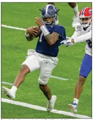  ?? (AP/Matthew Hinton) ?? Georgia Southern quarterbac­k Shai Werts (left) pulls away from Louisiana Tech defensive back Zach Hannibal to score the second of his three touchdowns Wednesday in the New Orleans Bowl.