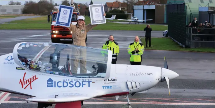  ?? ?? Belgian- British pilot Zara Rutherford, 19, holds certificat­es following her landing at Kortrijk-Wevelgem Airport, after a round-the-world trip in a light aircraft, becoming the youngest female pilot to circle the planet alone, in Wevelgem, Belgium, January 20, 2022. Image: Reuters