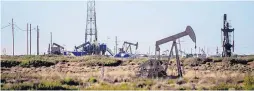  ?? ROBERTO E. ROSALES/JOURNAL ?? Rigs pump oil in June near the southeaste­rn New Mexico town of Loco Hills. Rising crude prices have spurred U.S. drillers to add 10 rigs this week.