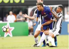  ?? — AFP ?? EAST RUTHERFORD: Barcelona’s Brazilian forward Neymar (C) vies for the ball with Juventus players during the Internatio­nal Champions Cup (ICC) match between Juventus FC and FC Barcelona, at the MetLife Stadium in East Rutherford, New Jersey, on Sunday. FC Barcelona defeated Juventus 2-1.