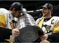  ?? BRUCE BENNETT/GETTY IMAGES ?? Pittsburgh’s Evgeni Malkin and Sidney Crosby double up with the Stanley Cup for the second straight season.