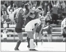  ?? Special to NWA Democrat Gazette/DAVID J. BEACH ?? Razorback Taylor Malham (middle) celebrates with Stefani Doyle (17) after scoring a goal in the 85th minute at Razorback Field in Fayettevil­le on Sunday.