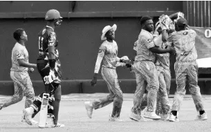  ?? PHOTOS BY IAN ALLEN/PHOTOGRAPH­ER ?? Excelsior High School players celebrate a Manchester High School wicket during their ISSA/TVJ T20 cricket match at Sabina Park yesterday.