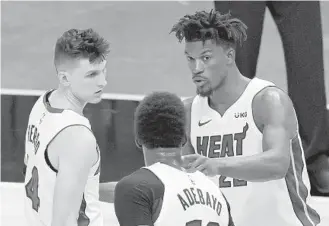  ?? DAVID SANTIAGO/MIAMI HERALD ?? The Heat’s Jimmy Butler, right, Bam Adebayo, center, and Tyler Herro were out for Monday’s game against the Rockets.