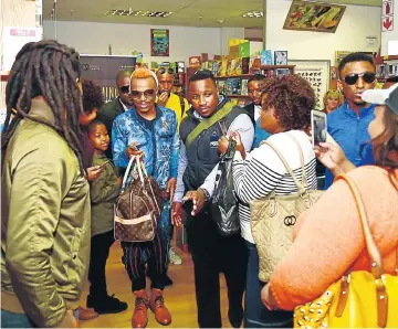  ?? Pictures: EUGENE COETZEE ?? STAR ATTRACTION: TV personalit­y Somizi Mhlongo is the centre of attraction at the Walmer Park Shopping Centre during a book launch visit