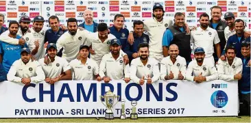  ?? — AFP ?? Unrivalled: India team members posing with their trophy after beating Sri Lanka in the Test series at the Feroz Shah Kotla Stadium in New Delhi yesterday.
