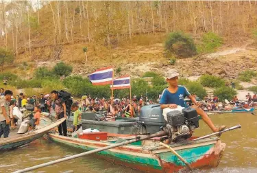  ?? Ei Tu Hta Community Leaders ?? Members of the ethnic Karen minority cross the Salween river into Thailand to seek refuge after air strikes hit Myanmar’s Karen state following last month’s military coup against an elected government.