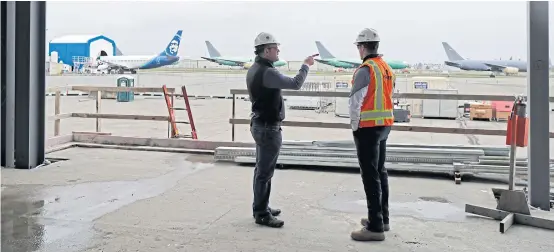 ?? AP ?? In this April 11, 2018 photo, Brett Smith, CEO of Propeller Investment­s LLC, left, talks with project engineer Todd Raynes inside the privately-run commercial US airport terminal Smith’s company is building at Paine Field in Everett, Washington.